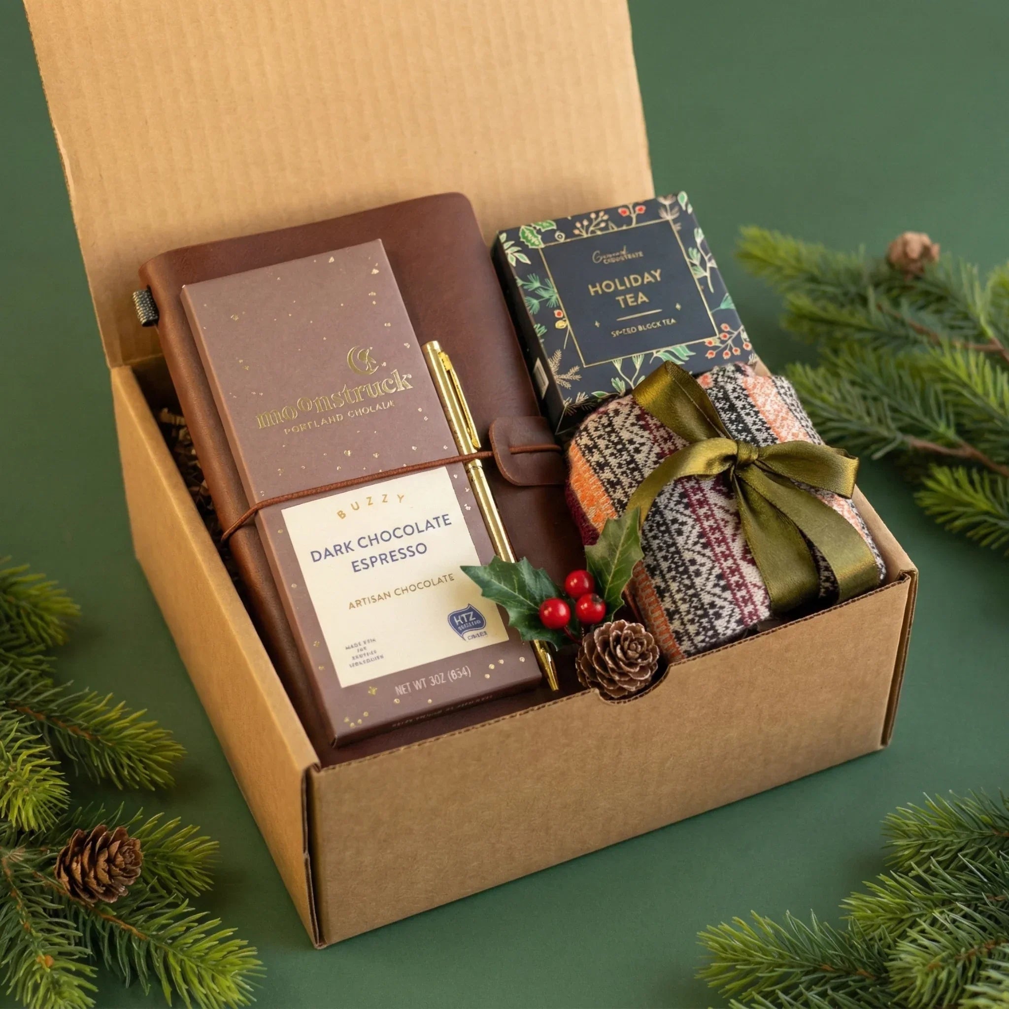 Curated corporate holiday gift box by Arinna Gifts featuring a premium leather journal, artisan dark chocolate, and cozy tea set.