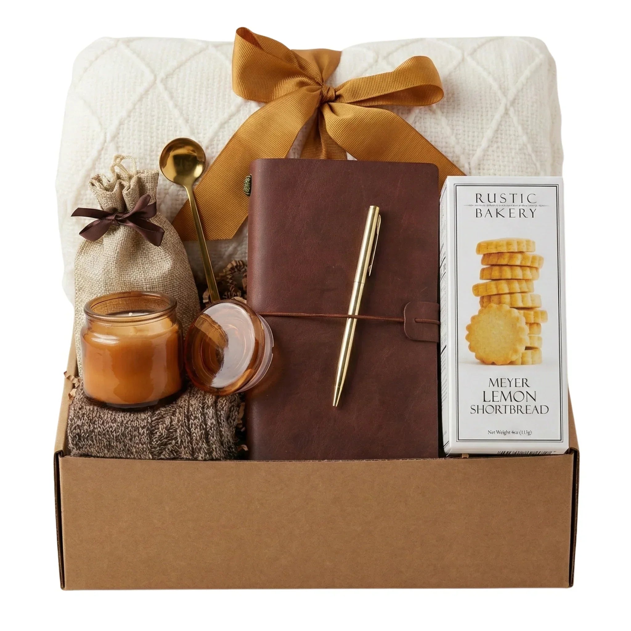 Curated remote employee onboarding gift box featuring a premium leather journal, cozy throw blanket, and gourmet snacks for a warm welcome.