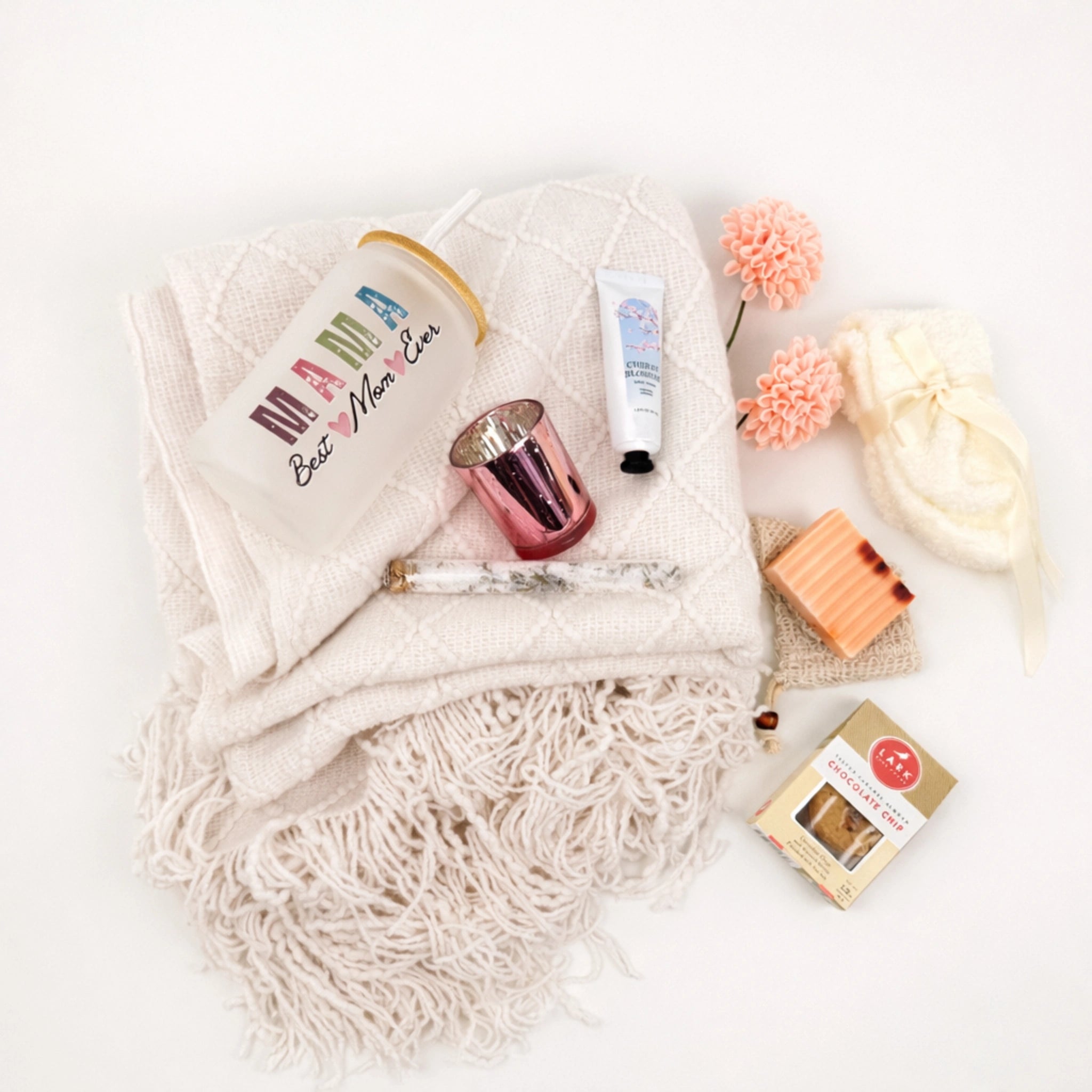 Flat lay Mother’s Day gift box for mom featuring blanket, tumbler, handmade soap, fluffy socks and candle holder