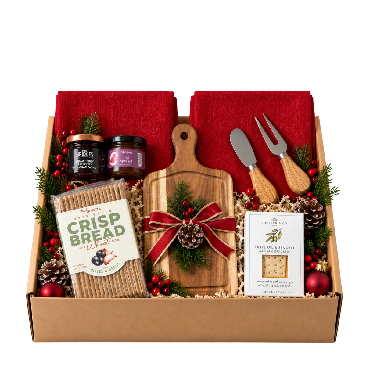 Christmas Eve gift box featuring acacia wood charcuterie board with cheese knives, artisan crackers, Danvita crispbread, fig spread, champagne jam, and red kitchen towels