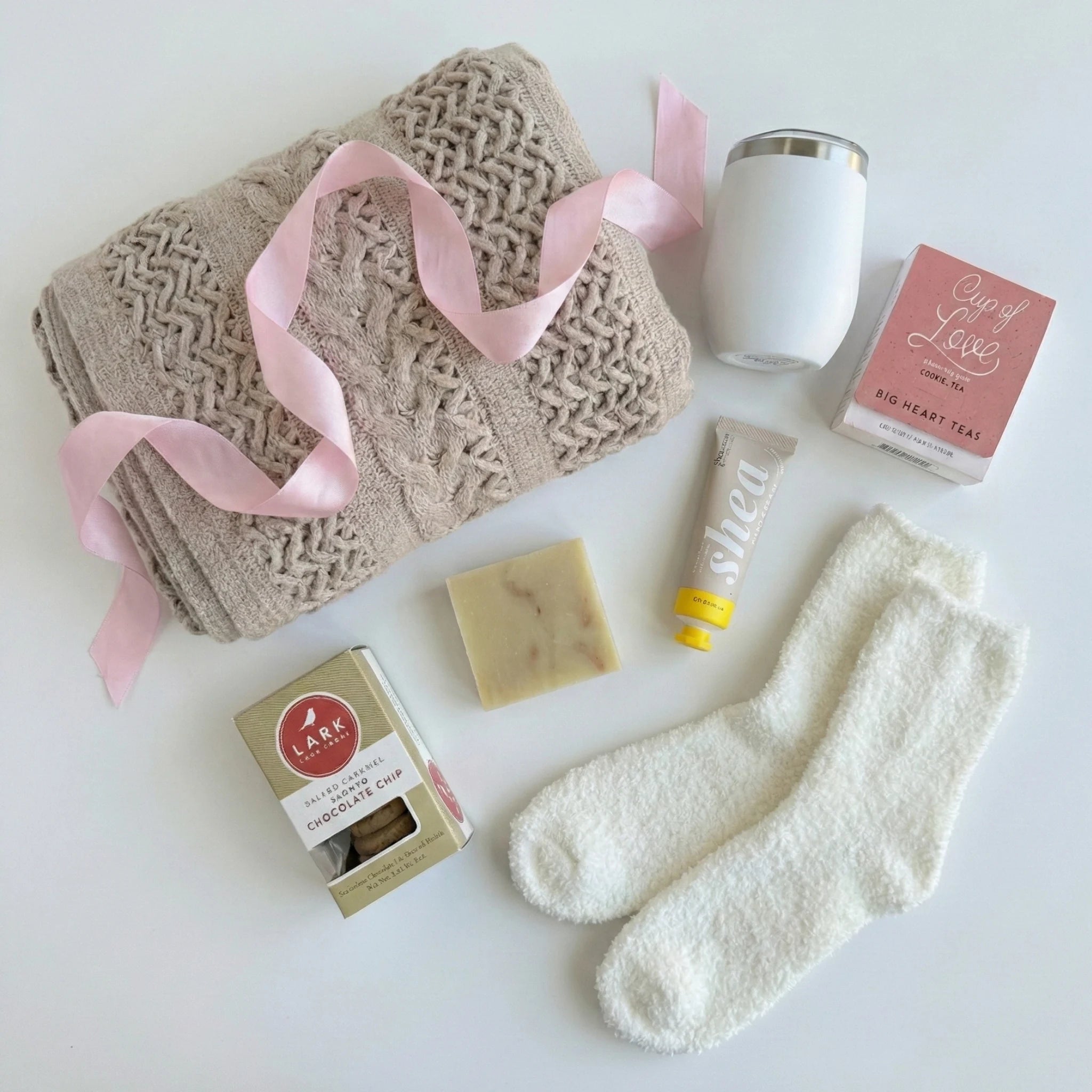 Top down flat lay view of Out of Office box items including Cup of Love tea and fluffy socks