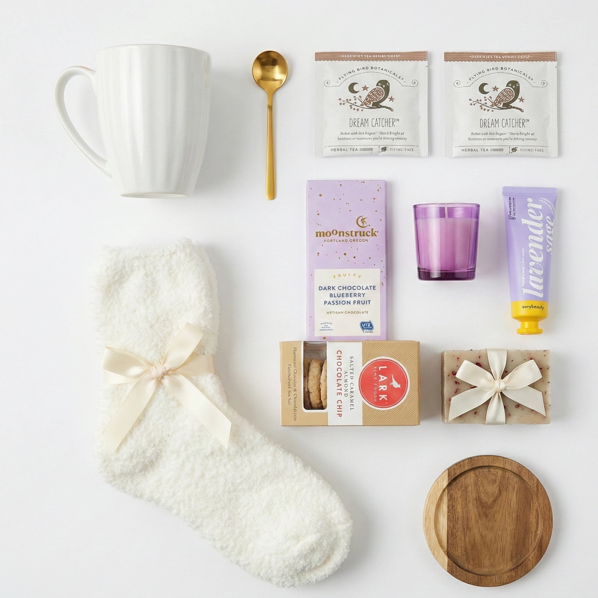 Top down flat lay view of Respect Gift Box items including purple candle and fuzzy socks
