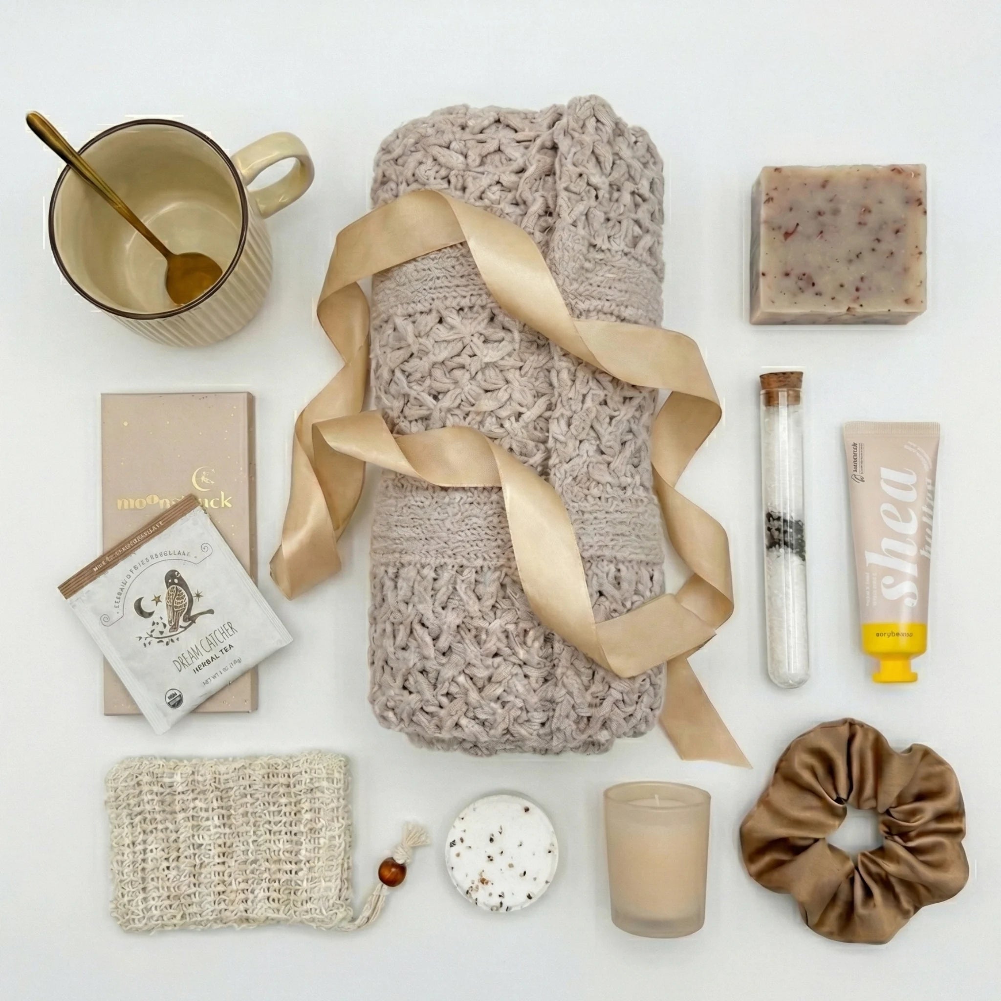 Top down flat lay view of Some Quiet box items including scrunchie, bath salt and chocolate
