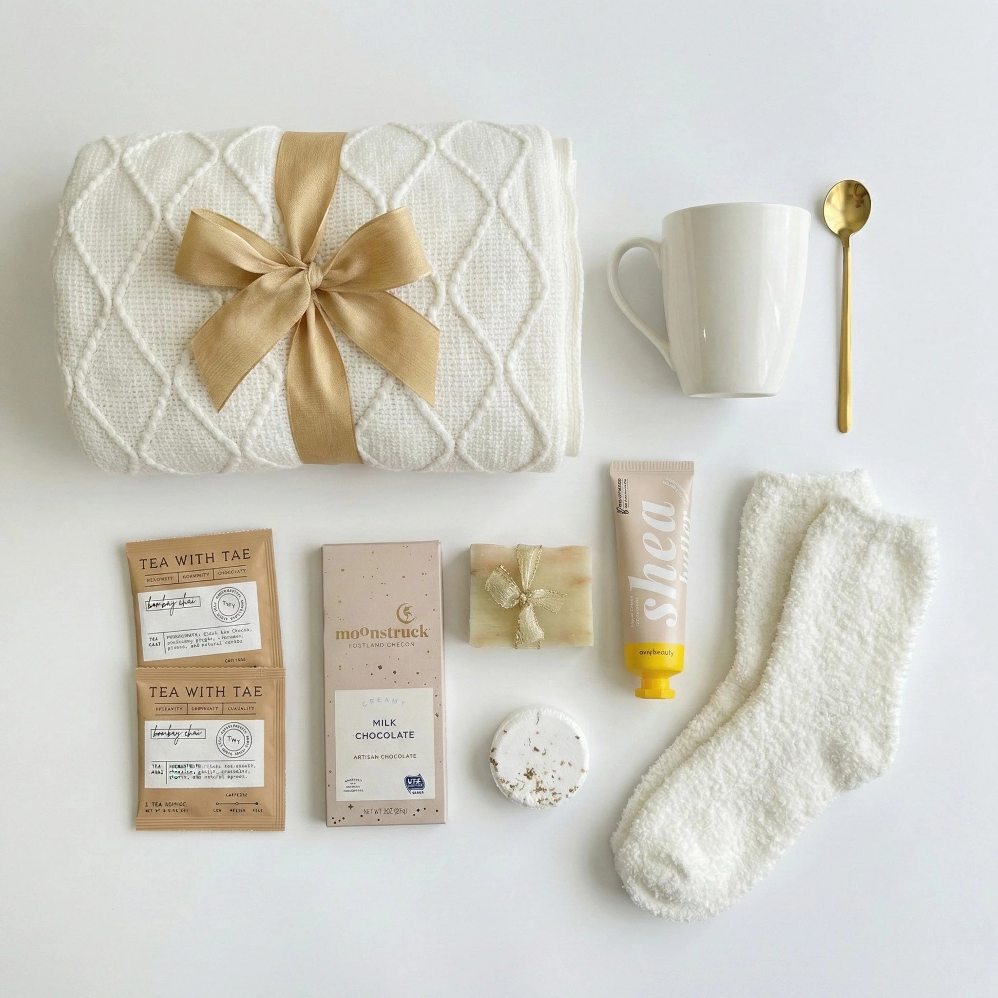 Top down flat lay view of Thinking of You gift box contents including gourmet treats and comfort items from Arinna Gifts