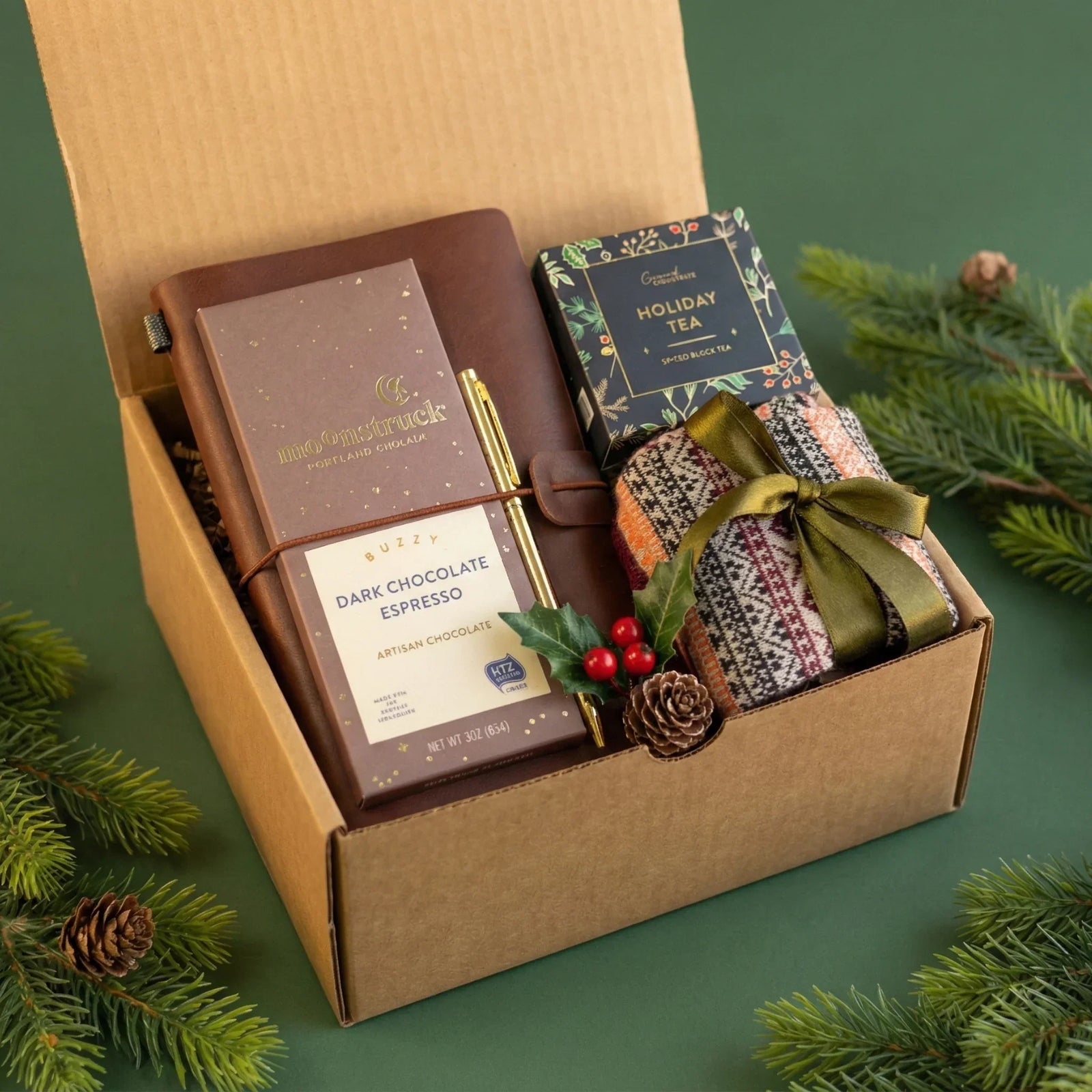 Curated corporate holiday gift box by Arinna Gifts featuring a premium leather journal, artisan dark chocolate, and cozy tea set.