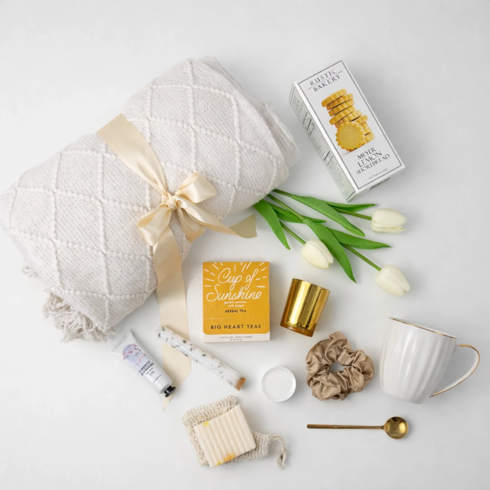 Luxuriously curated Hygge gift box for women featuring cozy blanket, gourmet treats, and premium spa essentials for relaxation and self-care. Perfect for Mother's Day, get well soon, or thinking of you gifts.