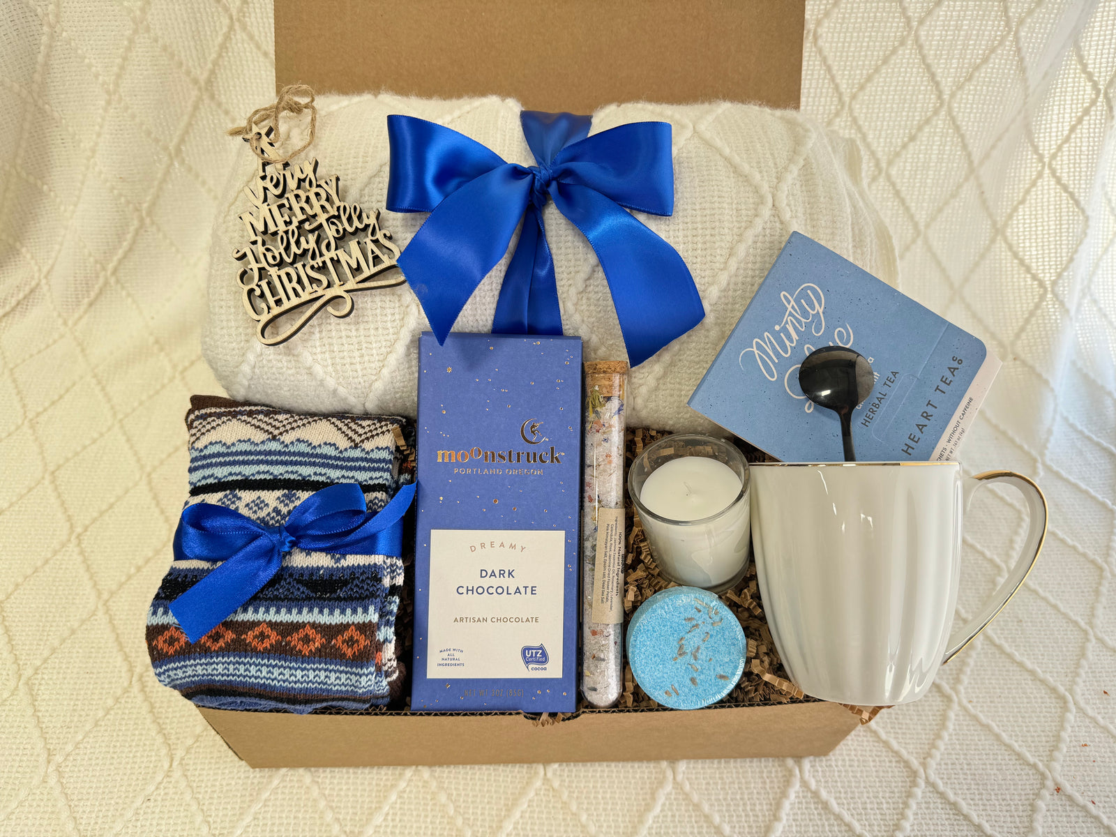 Blue Christmas Gift Box with White Knitted Blanket, blue ribbon and Minty Blue Tea by Arinna Gifts in Dallas