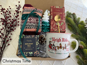 Christmas Time Gift Box featuring Nordic socks, holiday tea, gourmet cookie, Christmas tree candle, golden coffee spoon, and Christmas coffee mug.