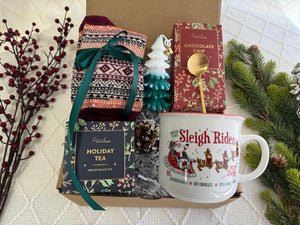 Christmas Time Gift Box featuring Nordic socks, holiday tea, gourmet cookie, Christmas tree candle, golden coffee spoon, and Christmas coffee mug.
