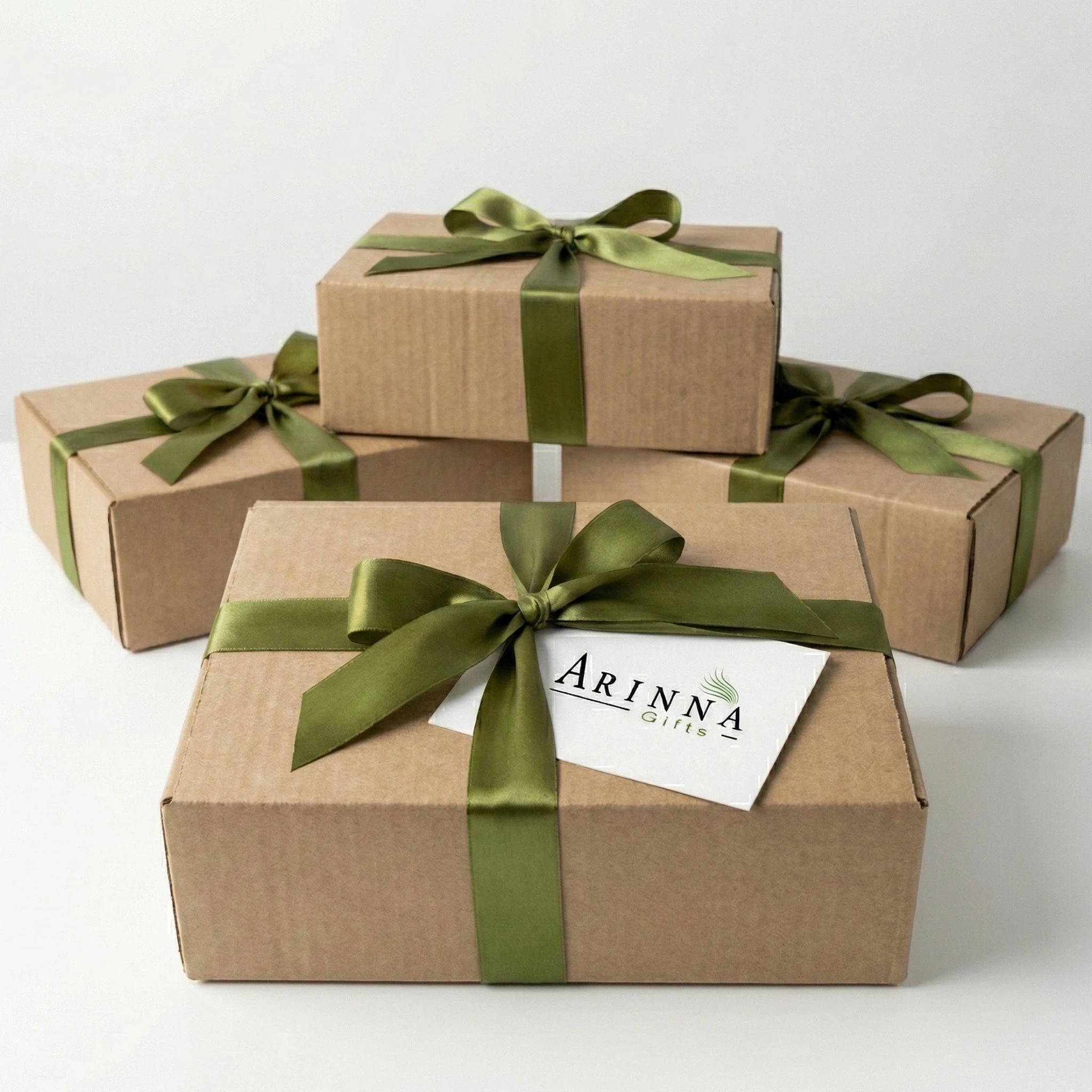 Arinna Gifts signature kraft gift box with green ribbon and branded card