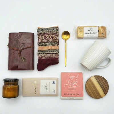 Top down flat lay view of journaling gift set items including milk chocolate and amber candle