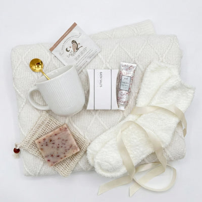 Top down flat lay view of Keep Calm box items including soap pouch, bath salts and fluffy socks