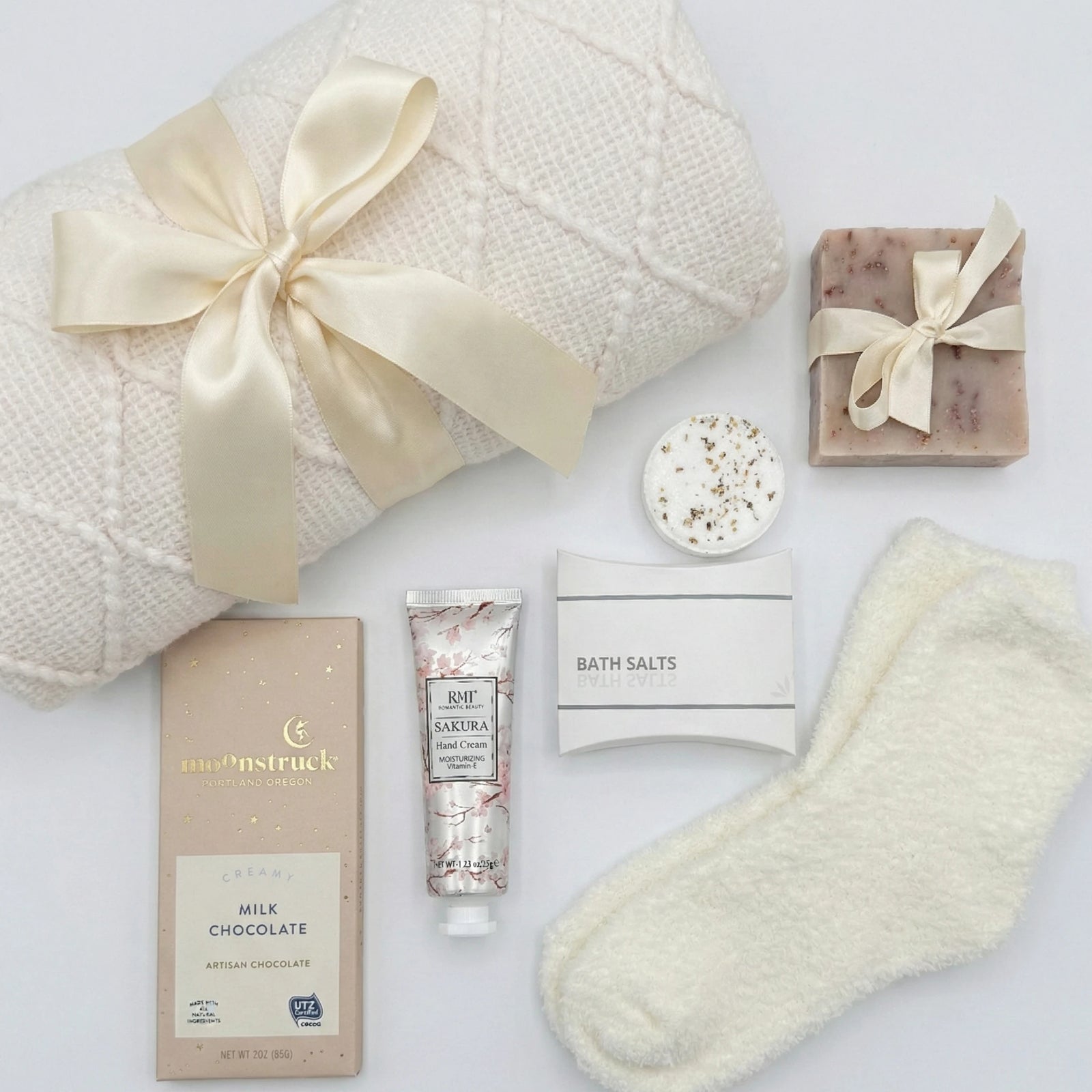 Love and Hugs gift basket with knit blanket, Moonstruck chocolate and spa items by Arinna Gifts in Dallas