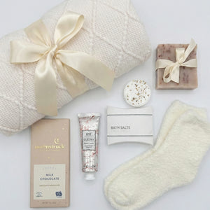 Top down flat lay view of Love and Hugs box items including handmade soap and bath salts