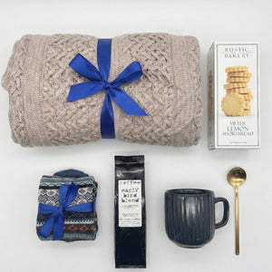 Top down flat lay view of Hygge gift set items including Early Bird coffee and nordic socks