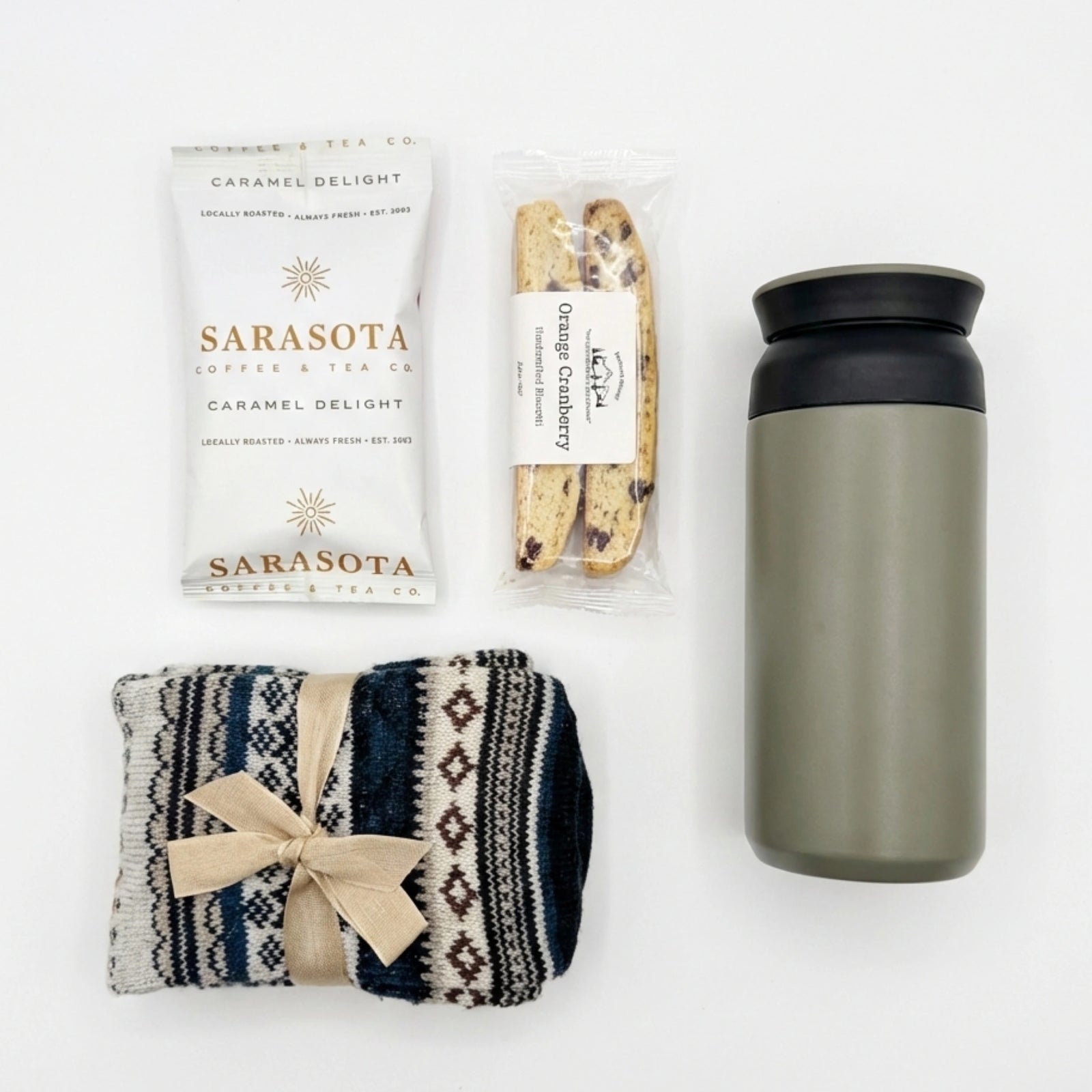 Nordic Warmth gift box featuring grey travel tumbler, caramel coffee, and wool socks by Arinna Gifts Dallas