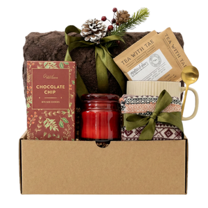 Santa Baby gift basket with brown blanket, chai tea and red candle by Arinna Gifts in Dallas