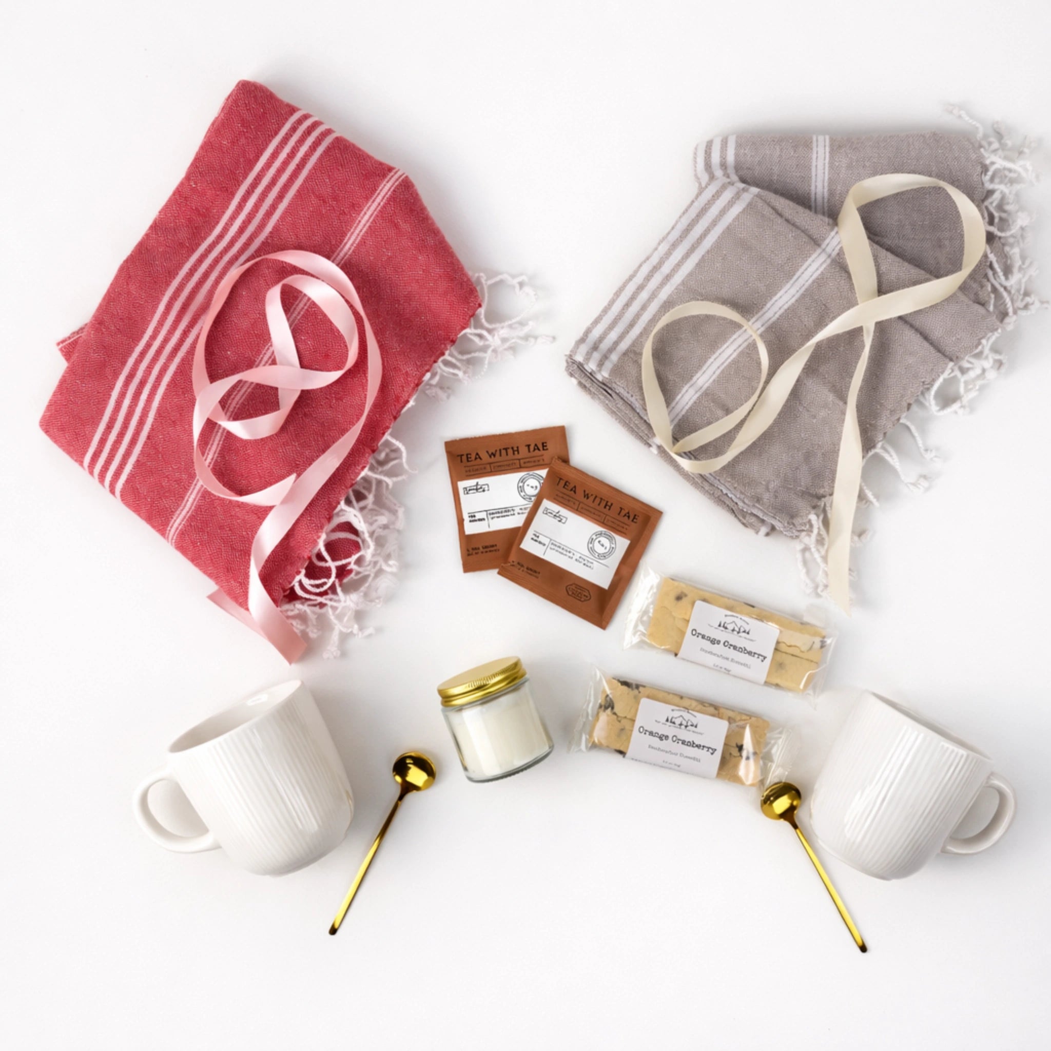 Flat lay seaside couple gift box featuring Turkish cotton towels, ceramic mugs with gold spoons, herbal tea sachets, shortbread cookies and candle