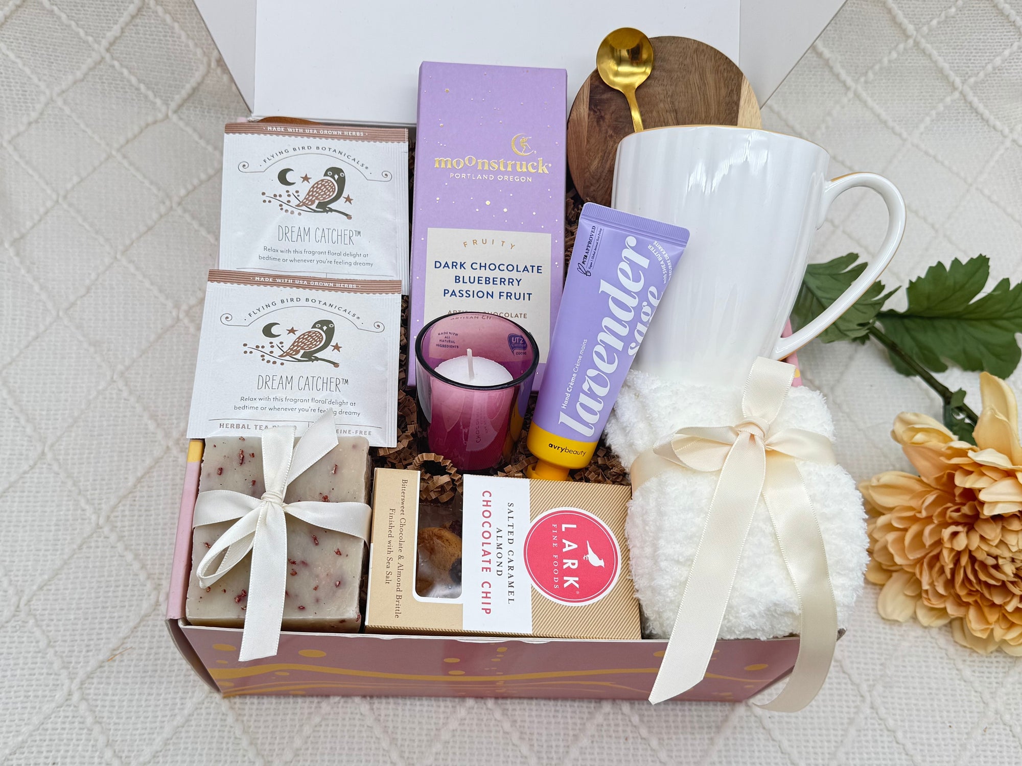 Cozy self-care gift box with tea, chocolate, candle and spa items