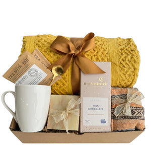 Sending Kisses cheerful gift basket with yellow knit blanket, mug and chocolate for cheer up gift in Dallas