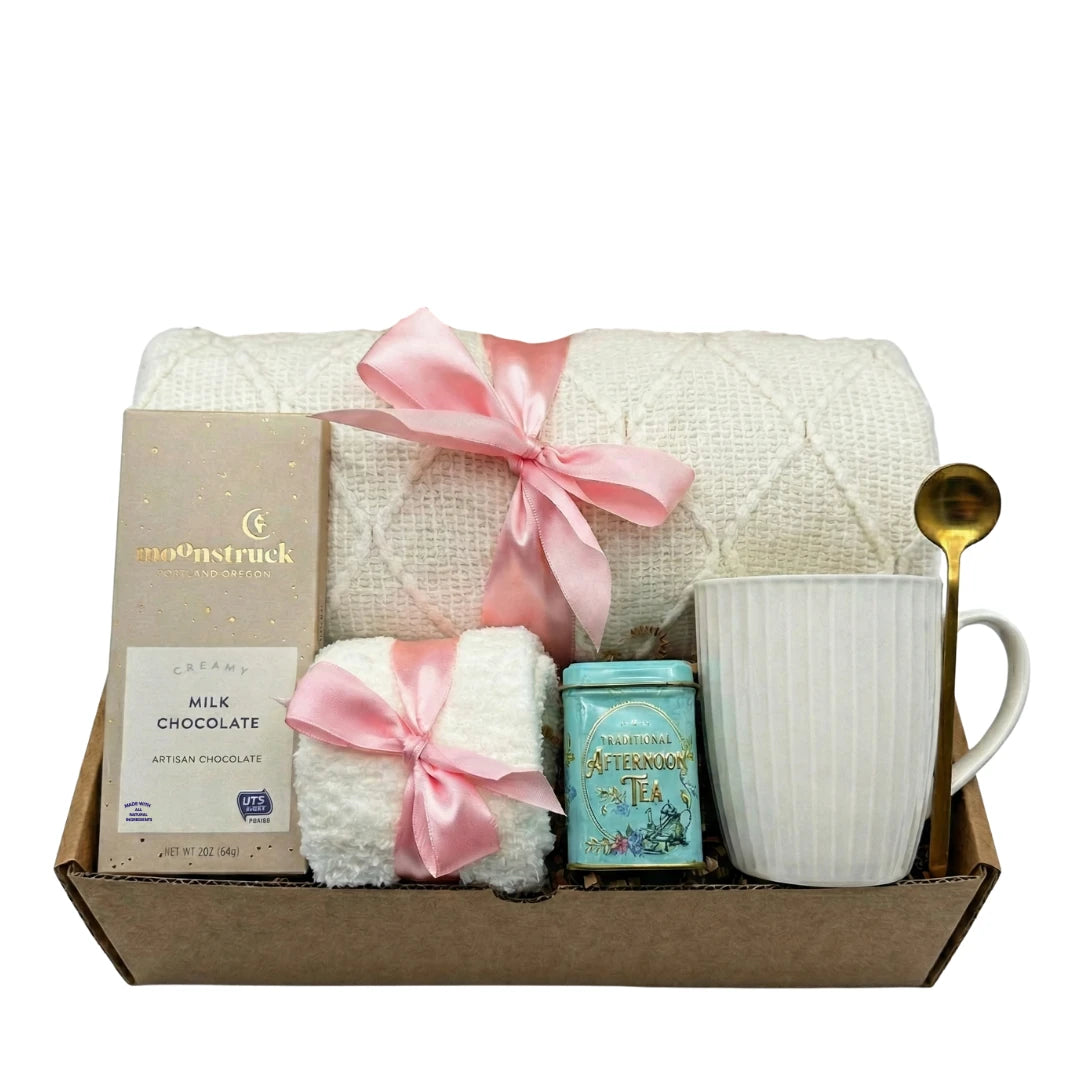 Sending Love and Hug gift basket with white knit blanket, pink ribbon and tea by Arinna Gifts in Dallas