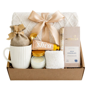 Serenity gift box featuring white knit blanket, shea cream, and Moonstruck chocolate by Arinna Gifts Dallas