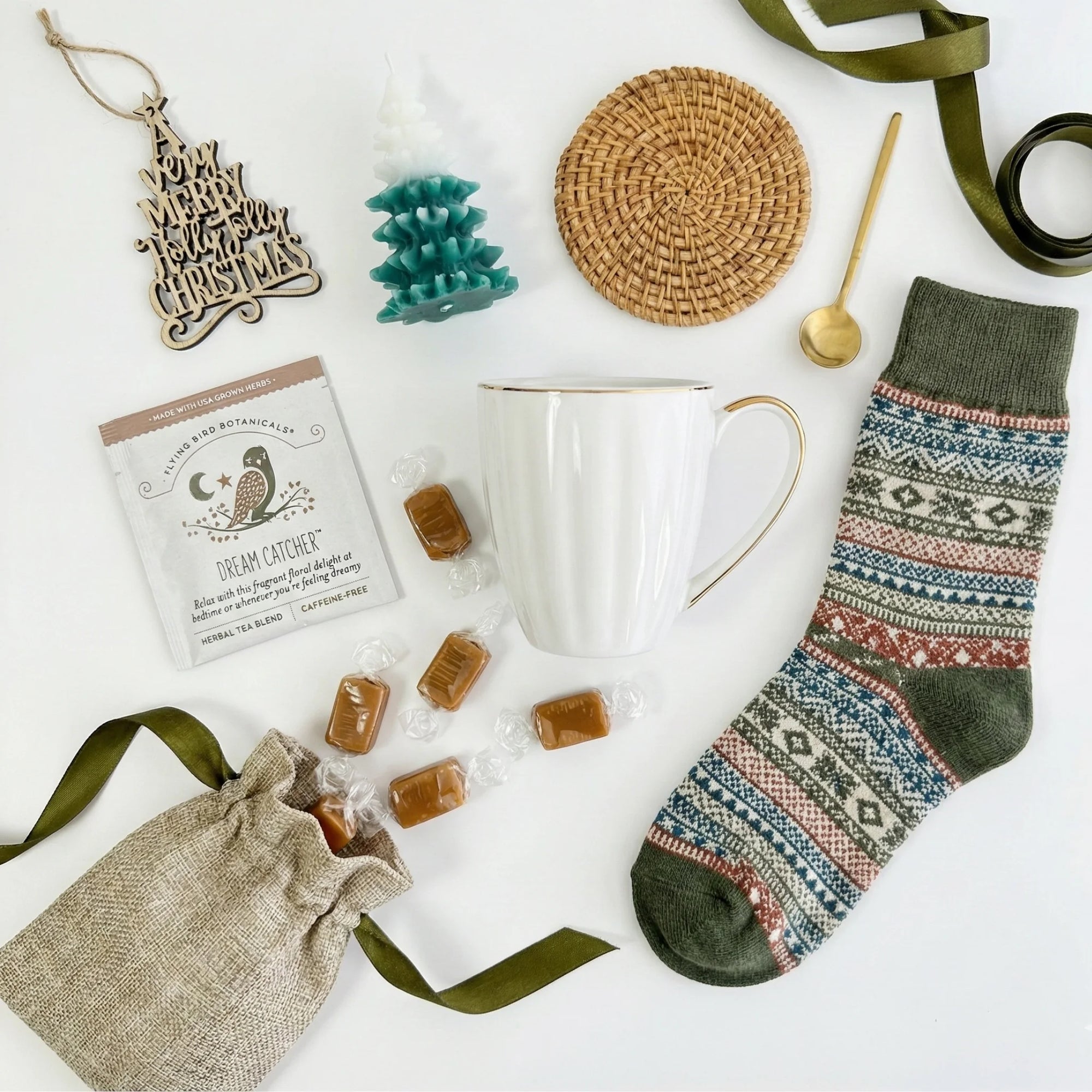 Top down flat lay view of Silent Night box items including wooden ornament and tree candle