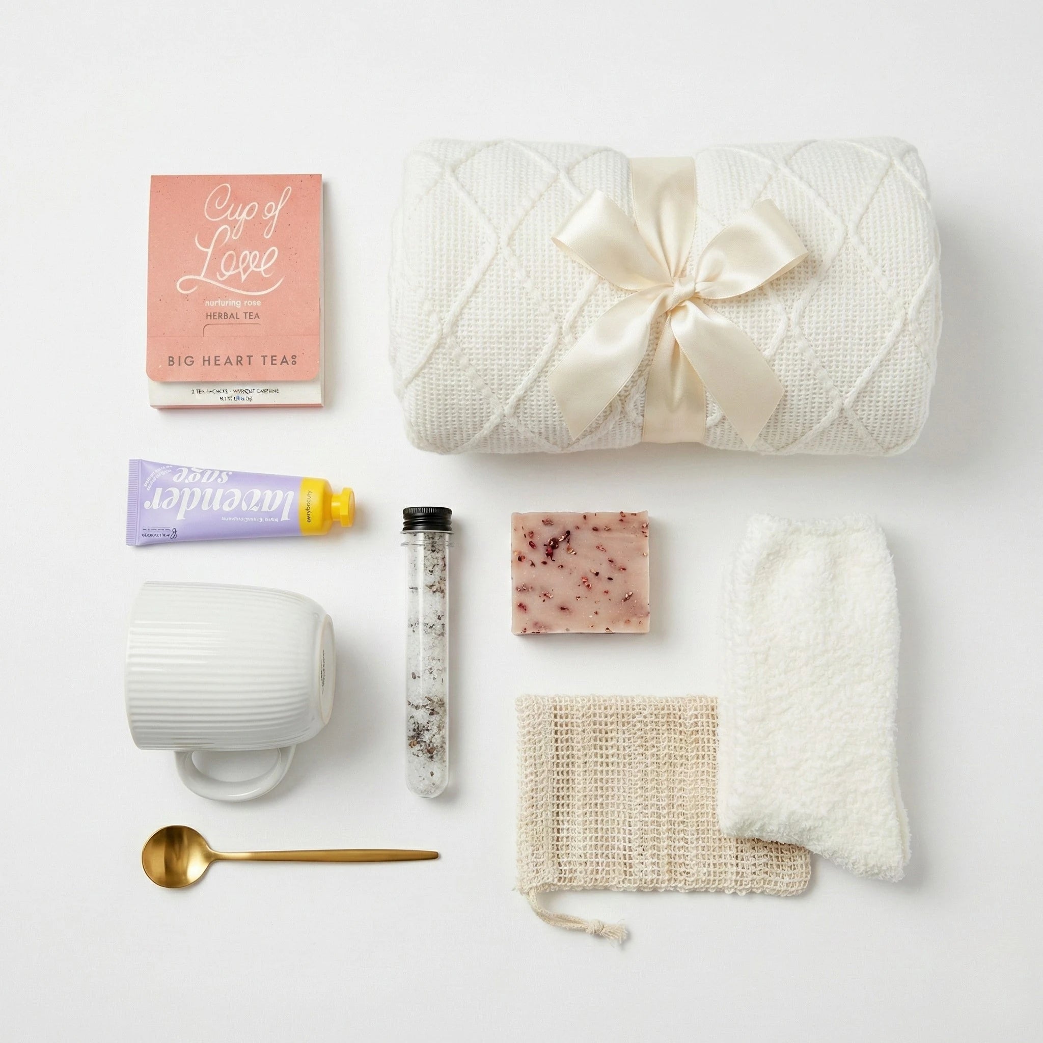 Top down flat lay view of Spa gift set items including fuzzy socks and herbal tea