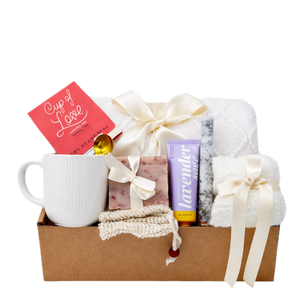 Spa On gift box featuring white knit blanket, Cup of Love tea, and lavender cream by Arinna Gifts Dallas