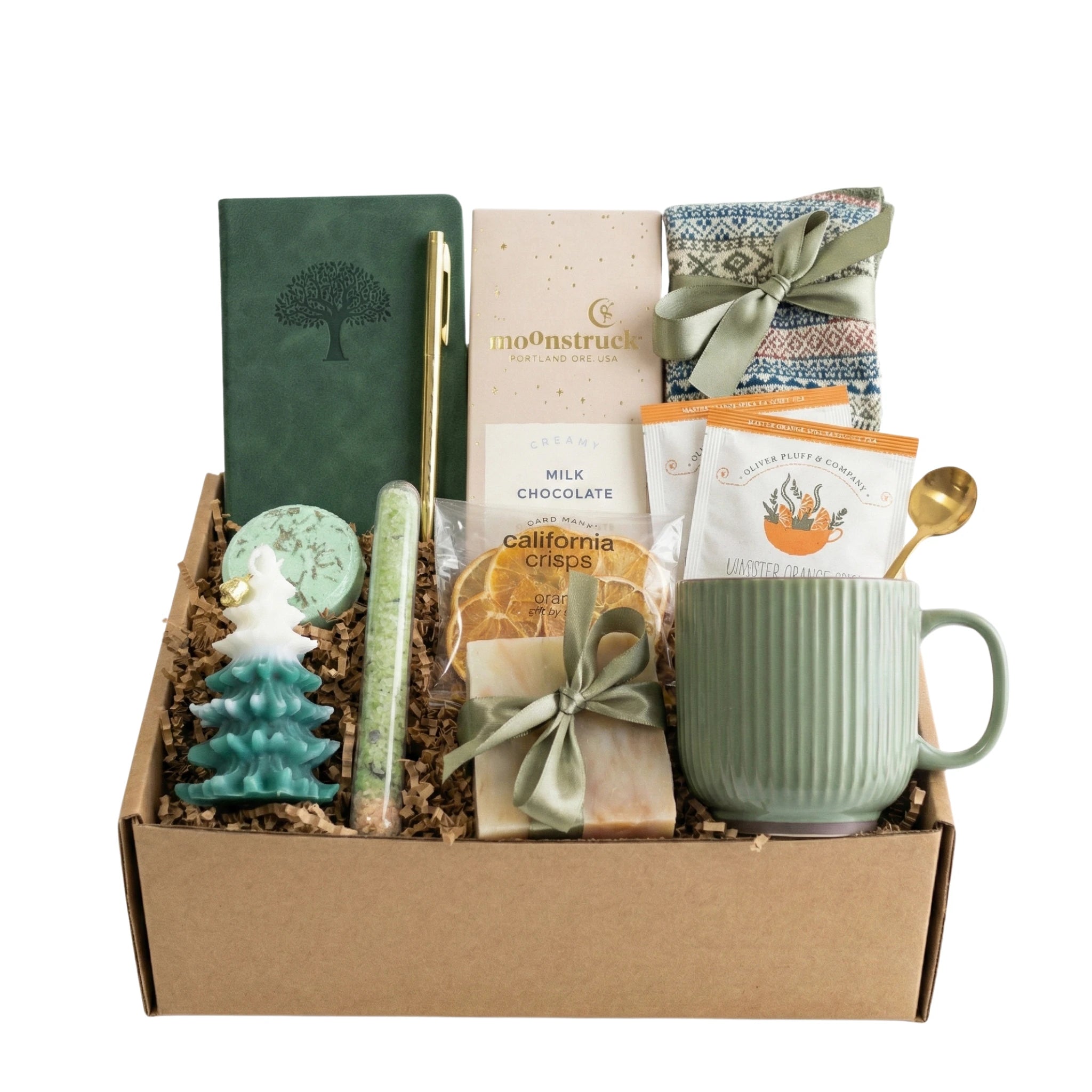 Winter Wonderland Gift Box featuring a pocket notebook, Nordic socks, dried orange slices, coffee mug, gourmet chocolate, herbal tea, handmade soap, bath salt, shower steamer, Christmas tree candle, and golden pen.