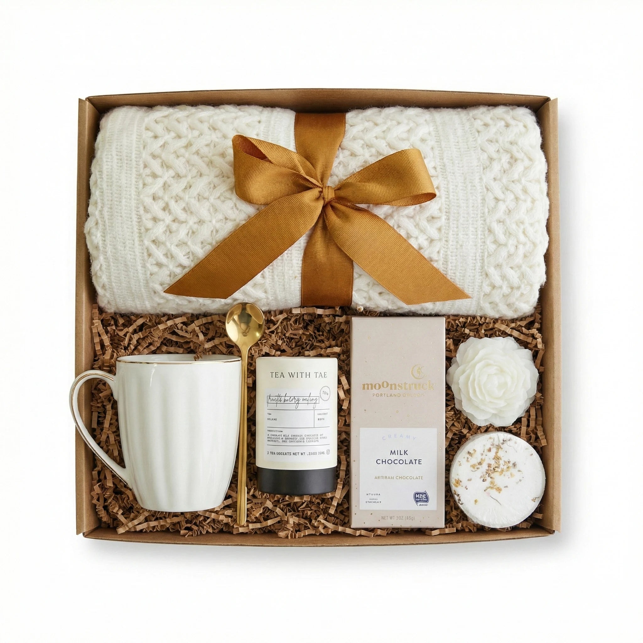 Top down flat lay view in the gift box of You Matter box items including throw blanket and coffee mug